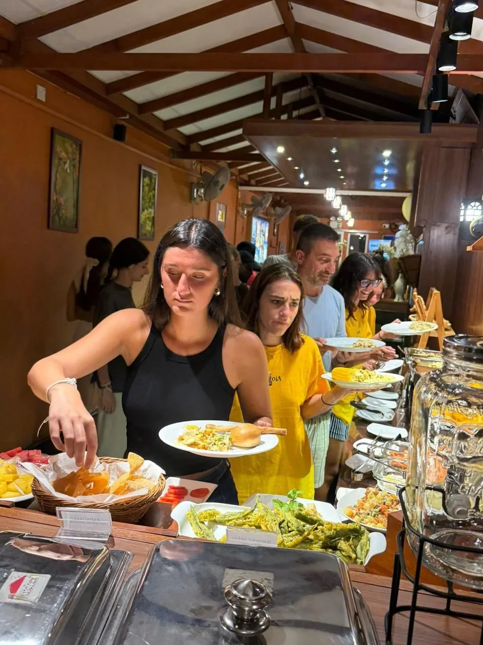 Guests serving food from the buffet line
